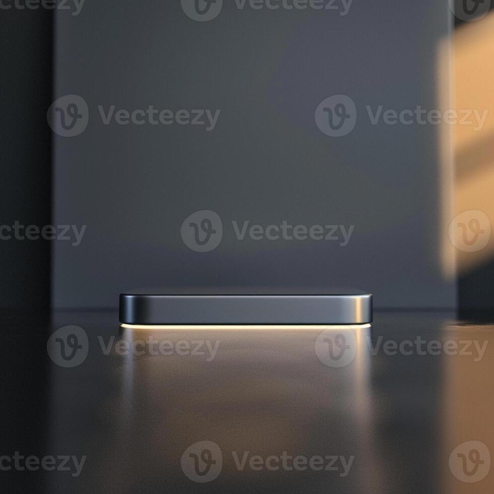 A silver box sitting on a table in front of a wall photo