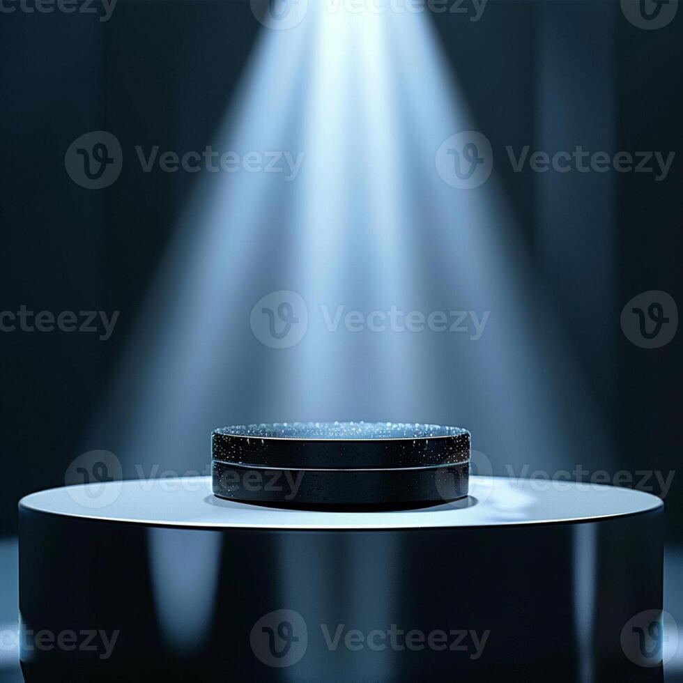 A spotlight shines on a black object on a table photo