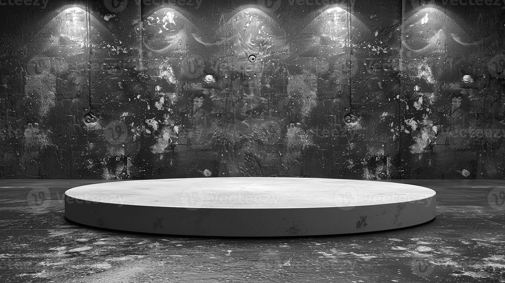 A black and white photo of a round table in front of a wall