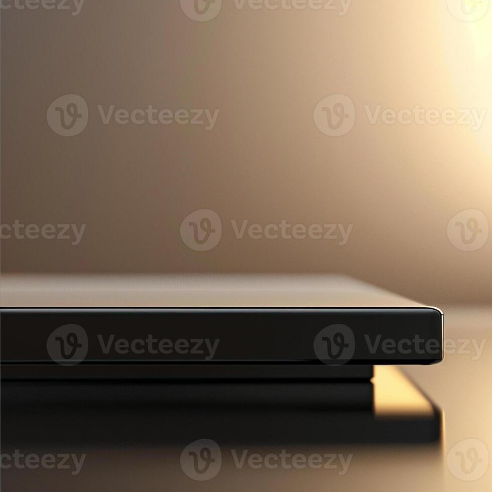 A black laptop on a table with a light shining on it photo