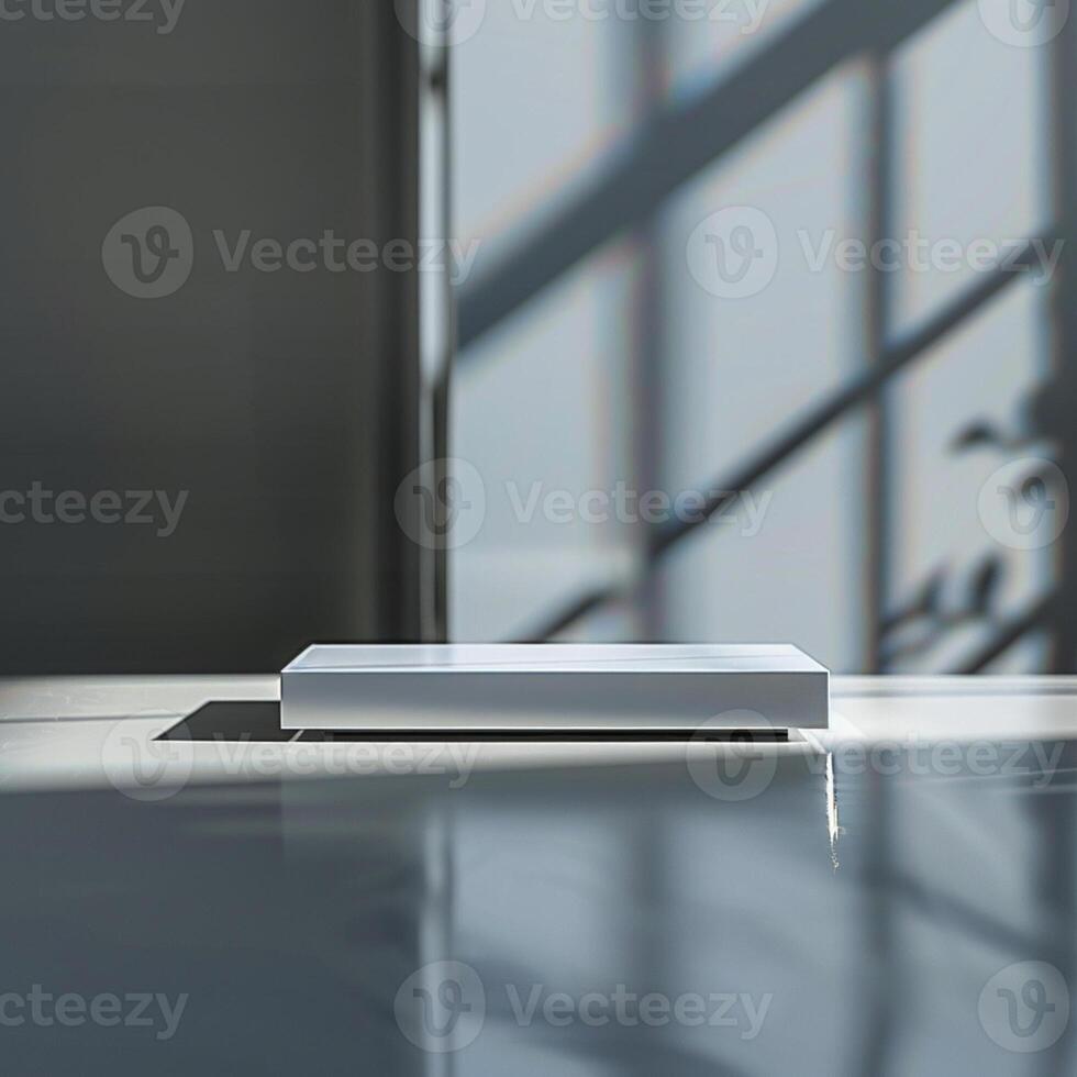 A white box sitting on a table in front of a window photo