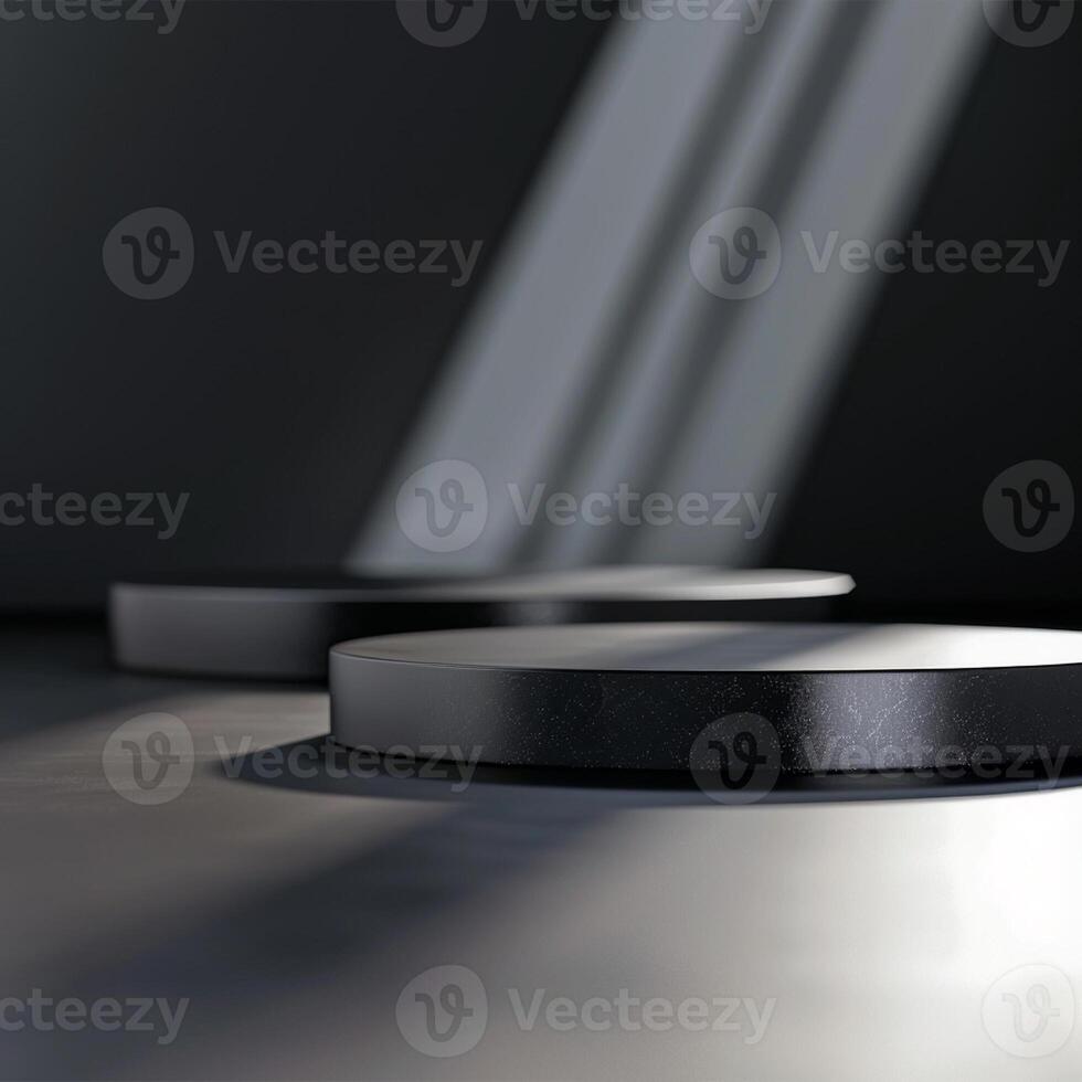 Two black round objects on a table in front of a wall photo