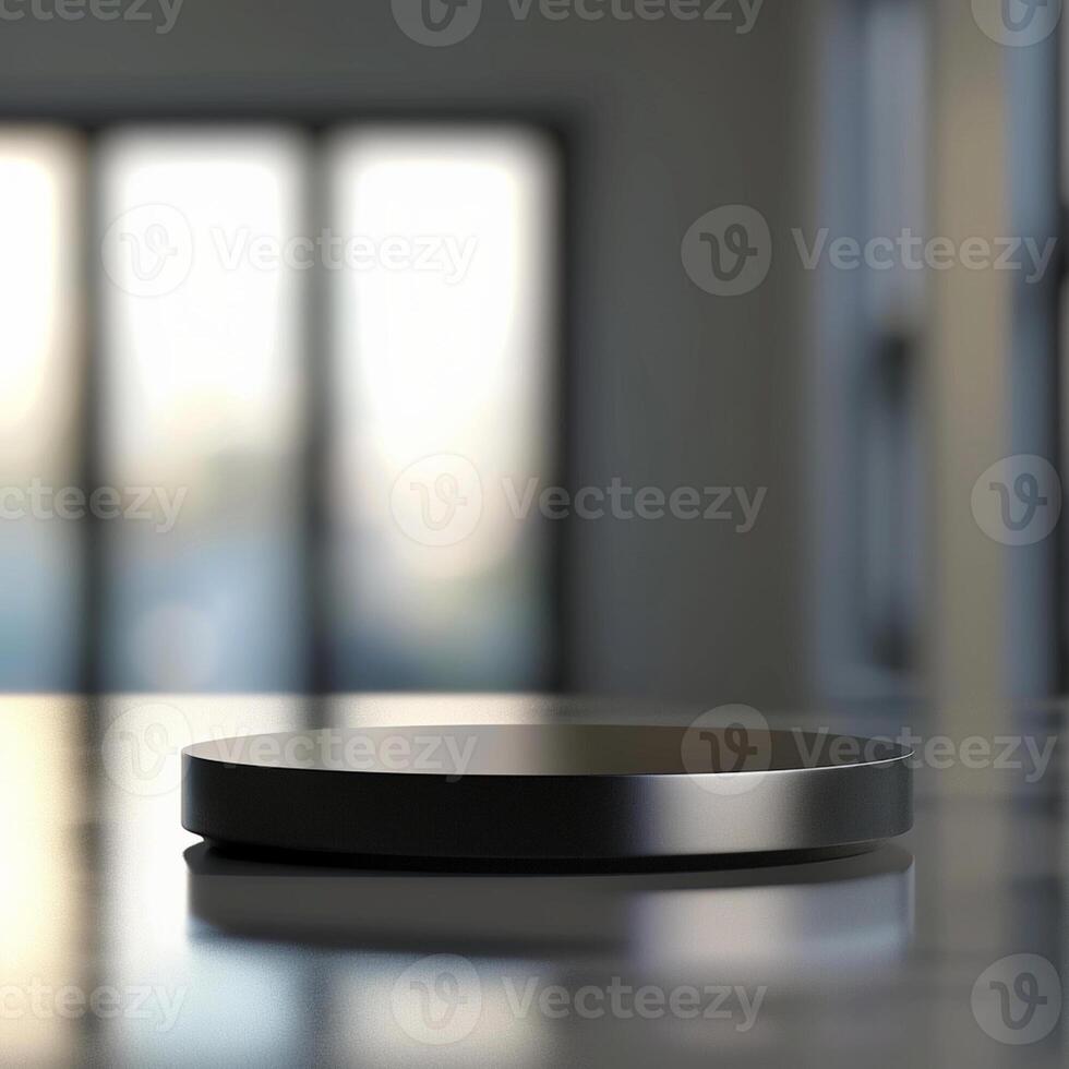 A black object on a table in front of a window photo