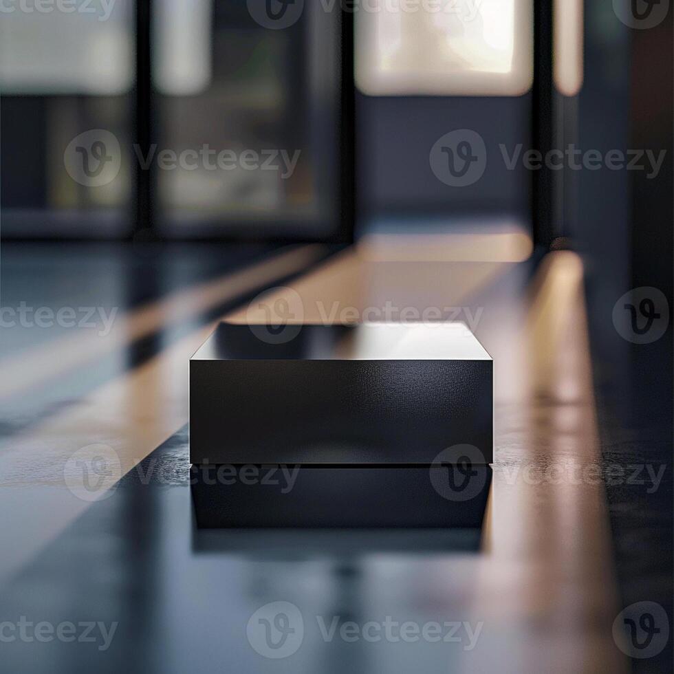 A black box sitting on the floor in front of a large window photo