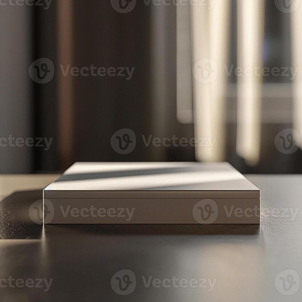 A white box sitting on a table in front of a window photo