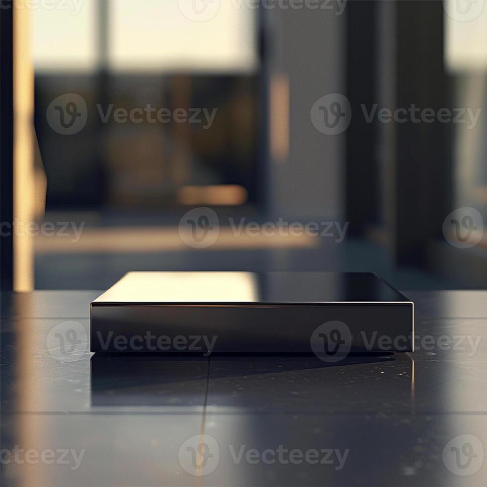 A black box sitting on a table in front of a window photo