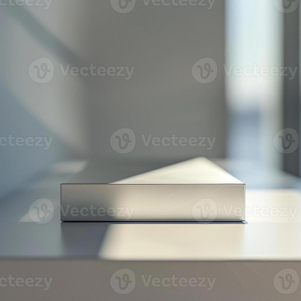 A white box sitting on a table in front of a window photo