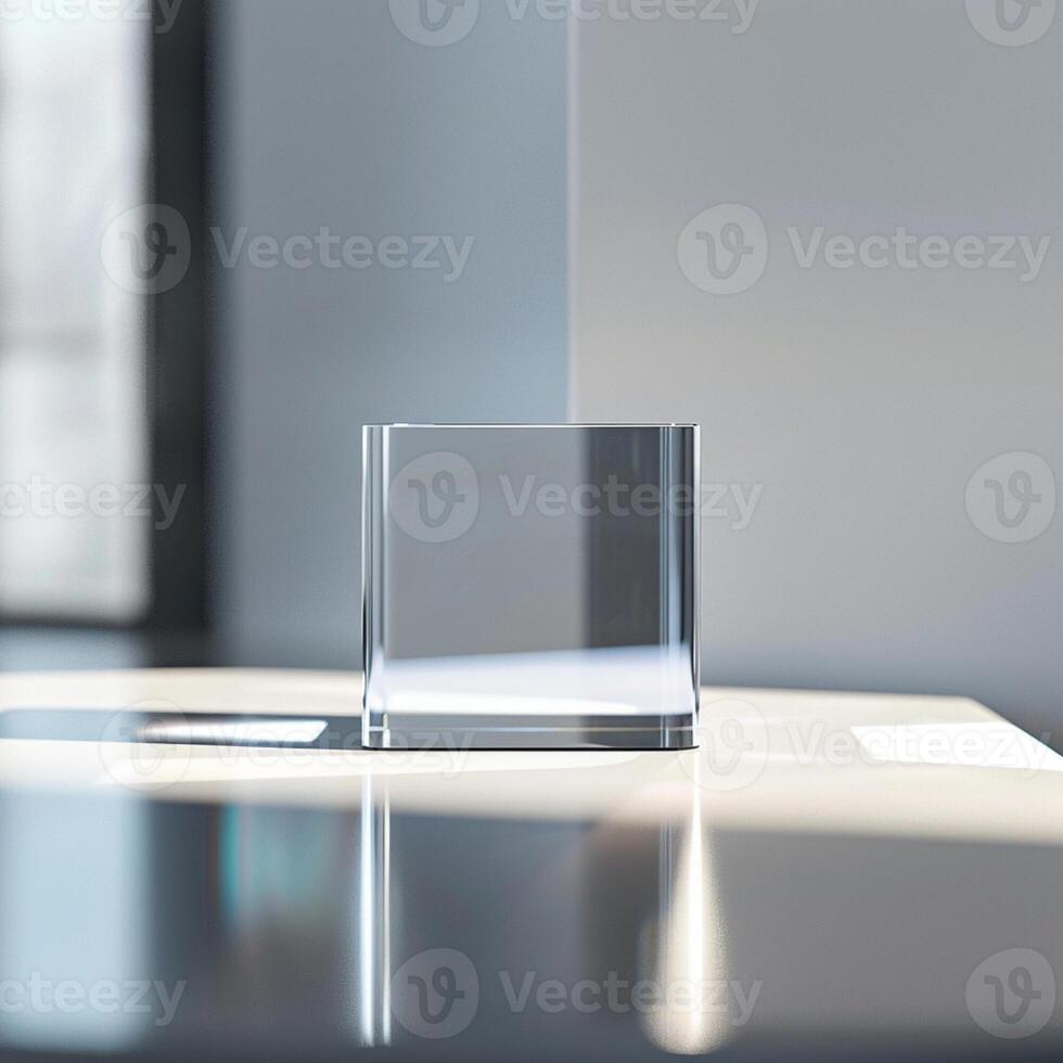 A glass cube sitting on a table in front of a window photo