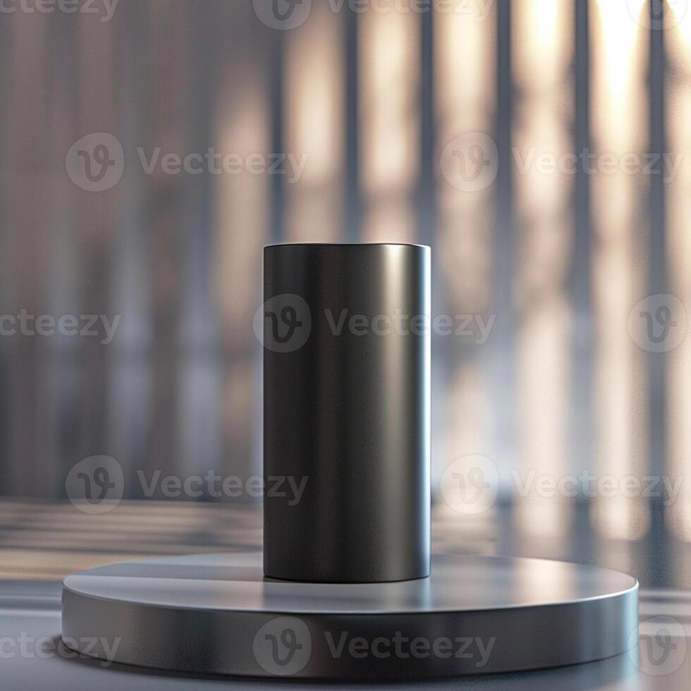 A black cylinder sitting on a pedestal photo