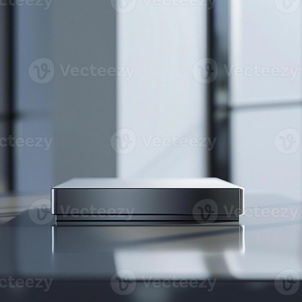 A silver box sitting on a table in front of a window photo