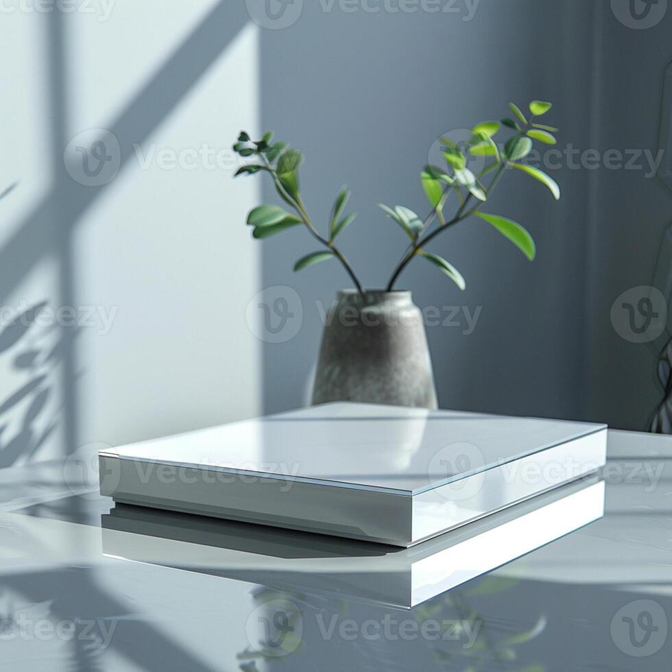 A white box sitting on a table next to a plant photo