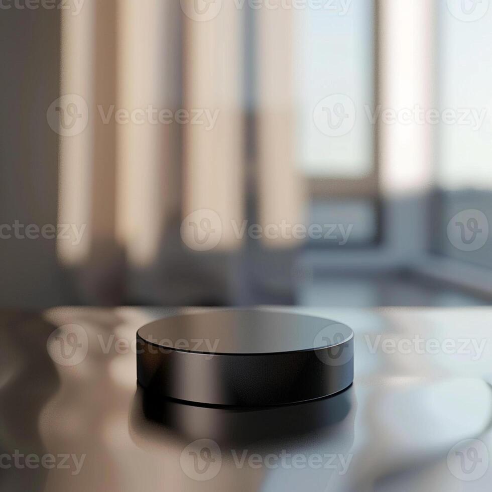 A black object sitting on a table in front of a window photo