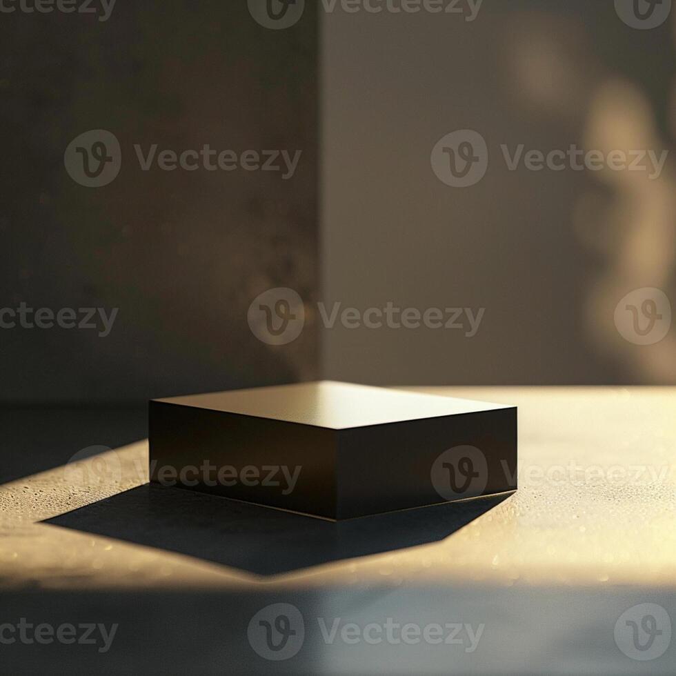 A black cube sitting on a table in front of a wall photo