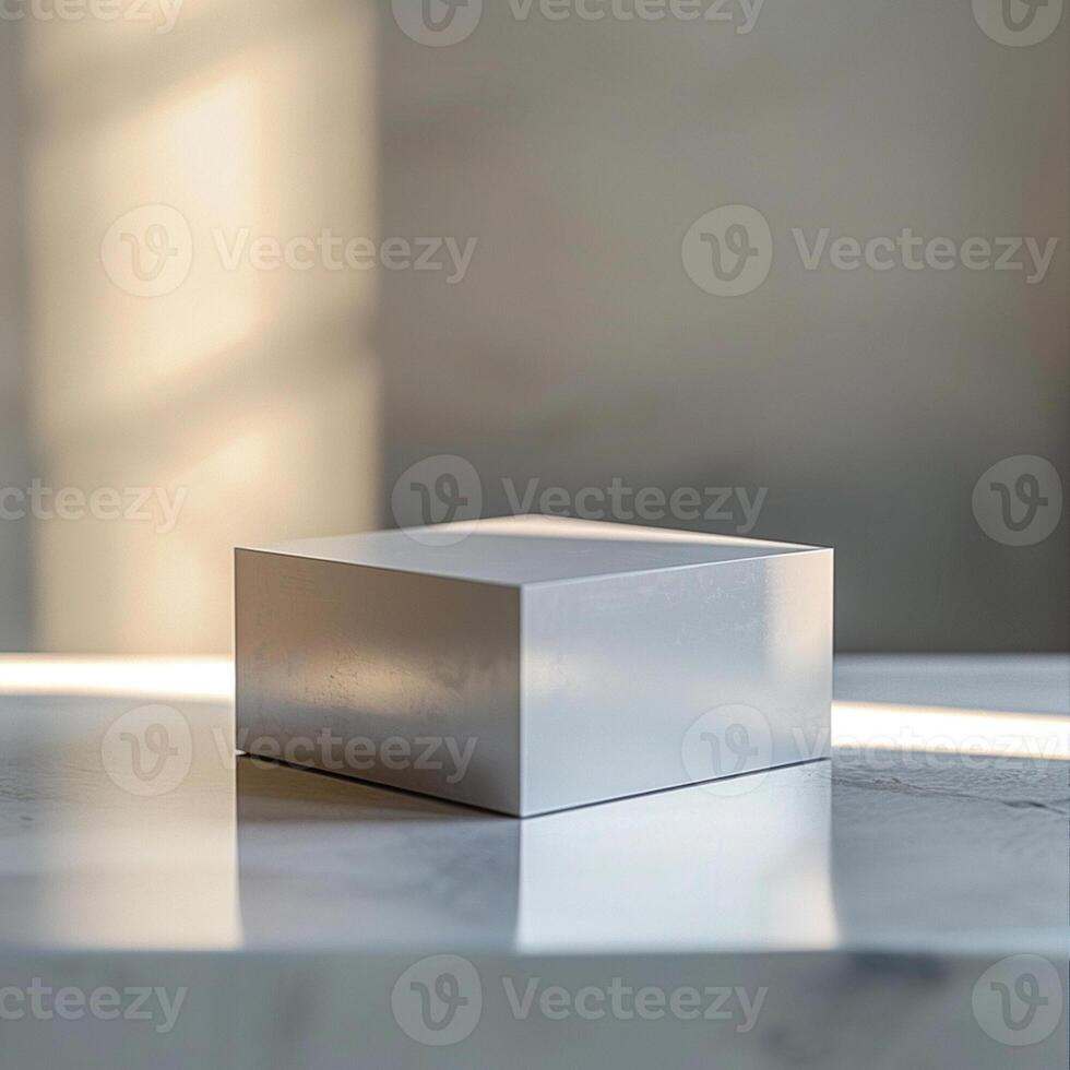 A white cube sitting on a table in front of a window photo