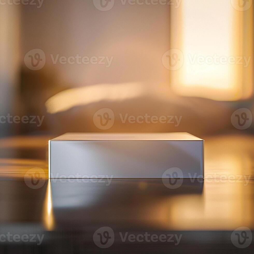 A white box sitting on a table in front of a window photo