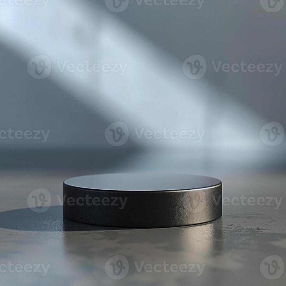 A black object sitting on a table in front of a wall photo
