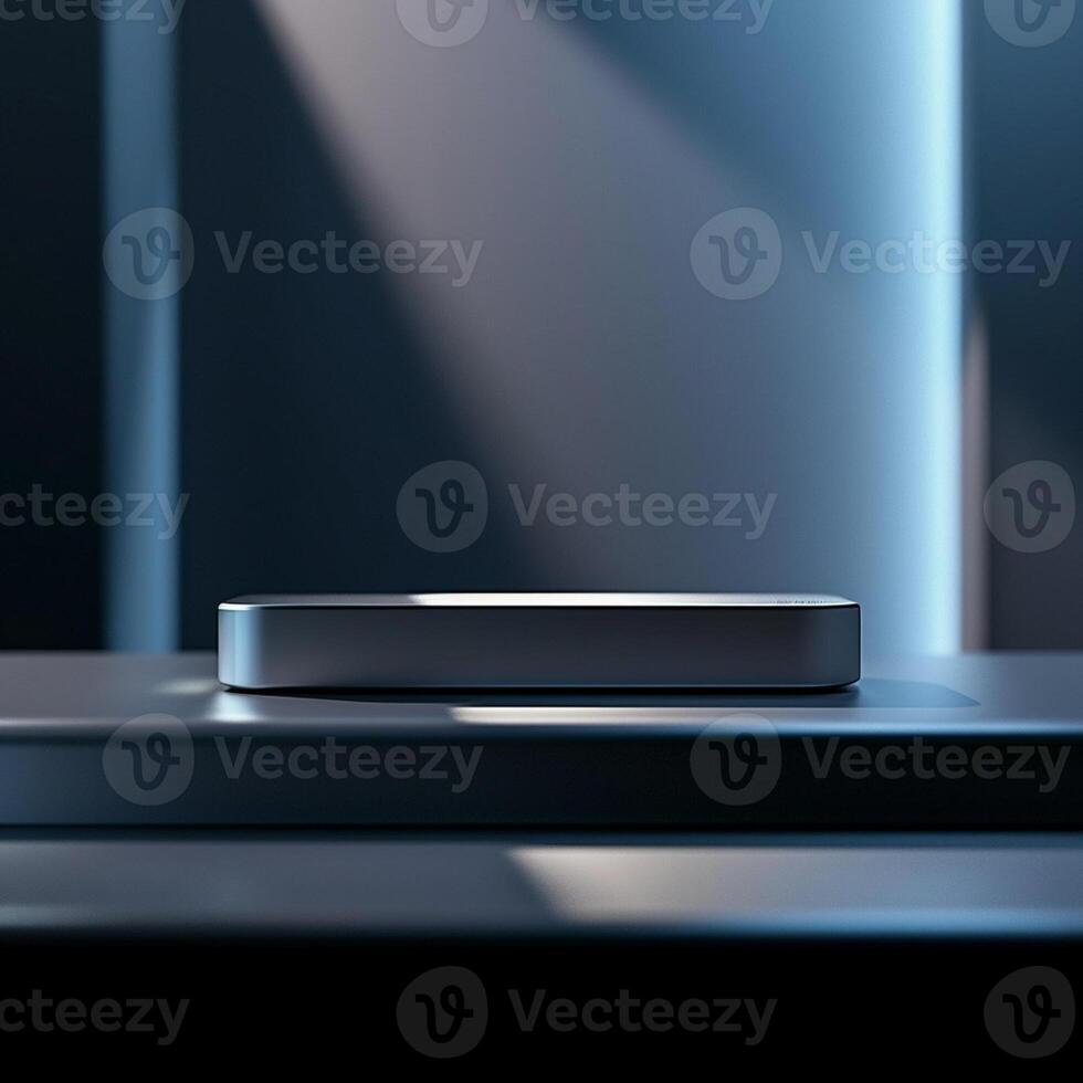 A silver box sitting on a table in front of a wall photo