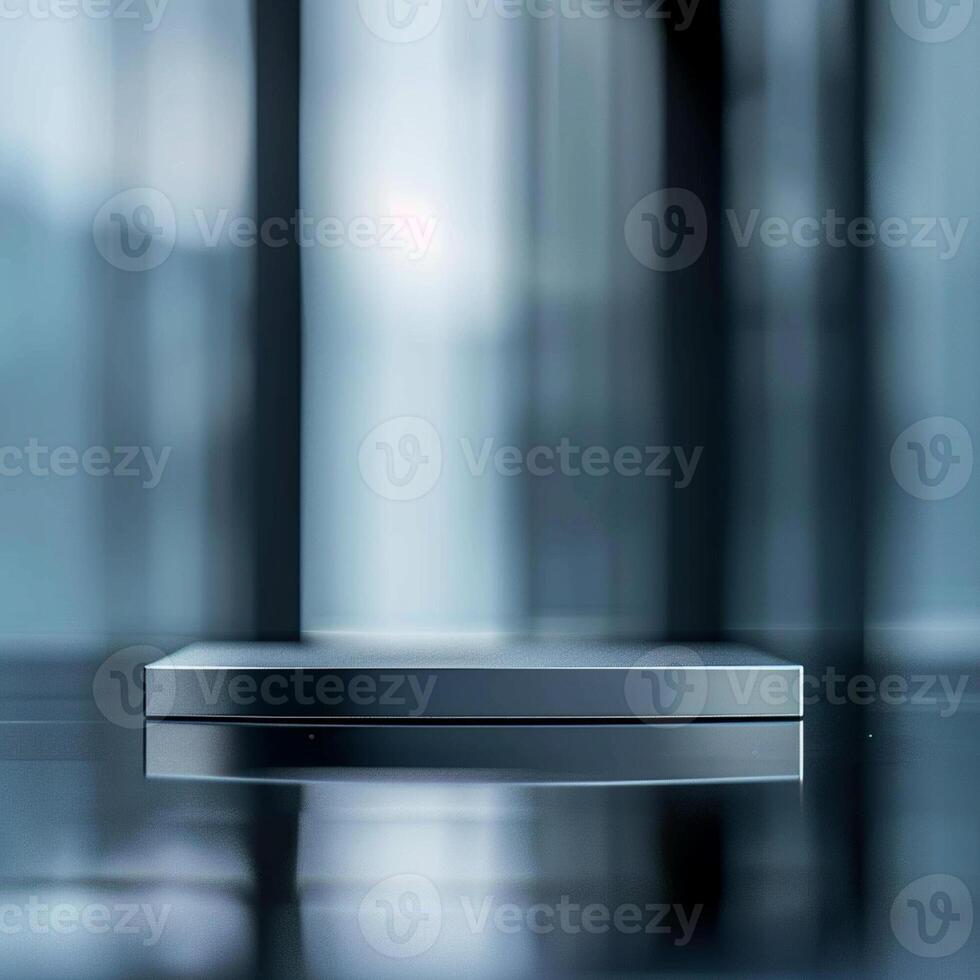 A silver box sitting on a table in front of a window photo