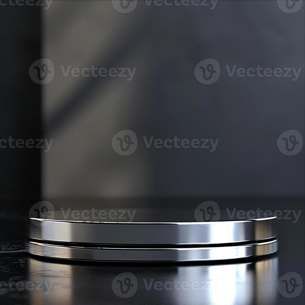 A silver circular object on a black surface photo