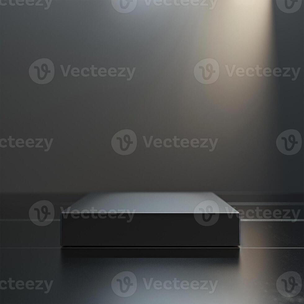 An empty black box on a dark floor with a spotlight photo