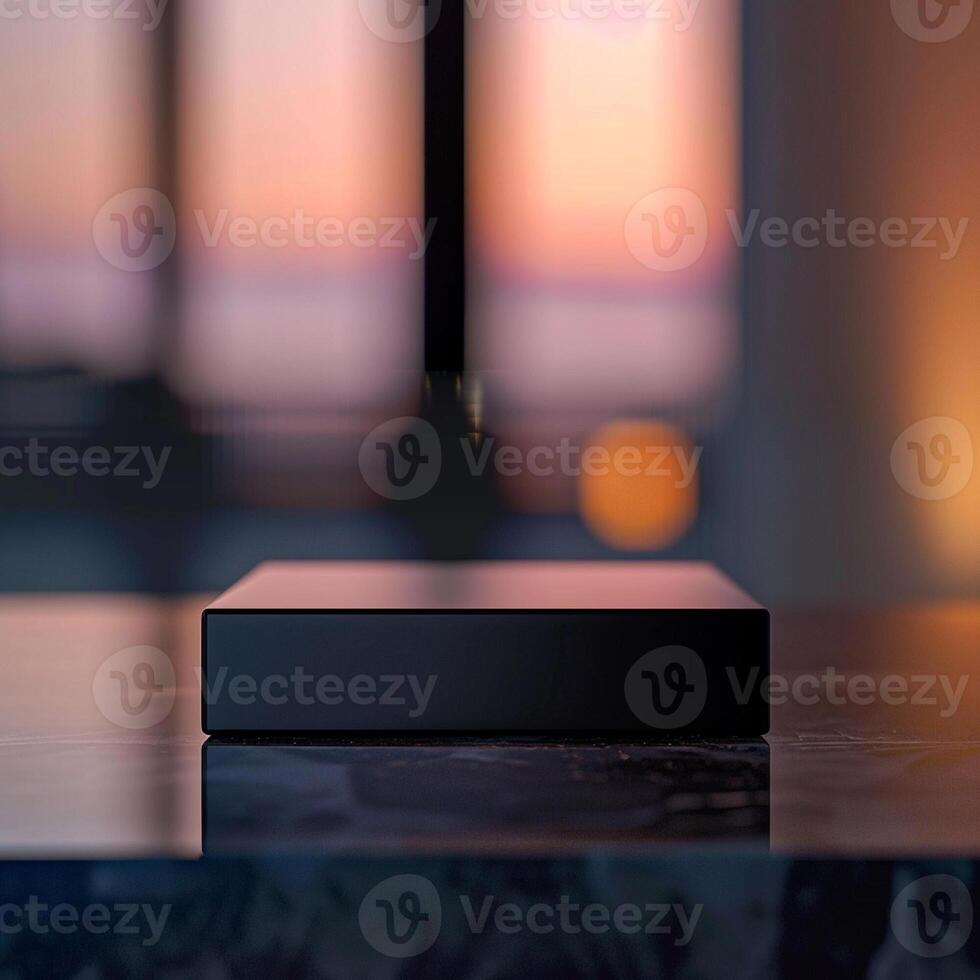 A black box sitting on a table in front of a window photo