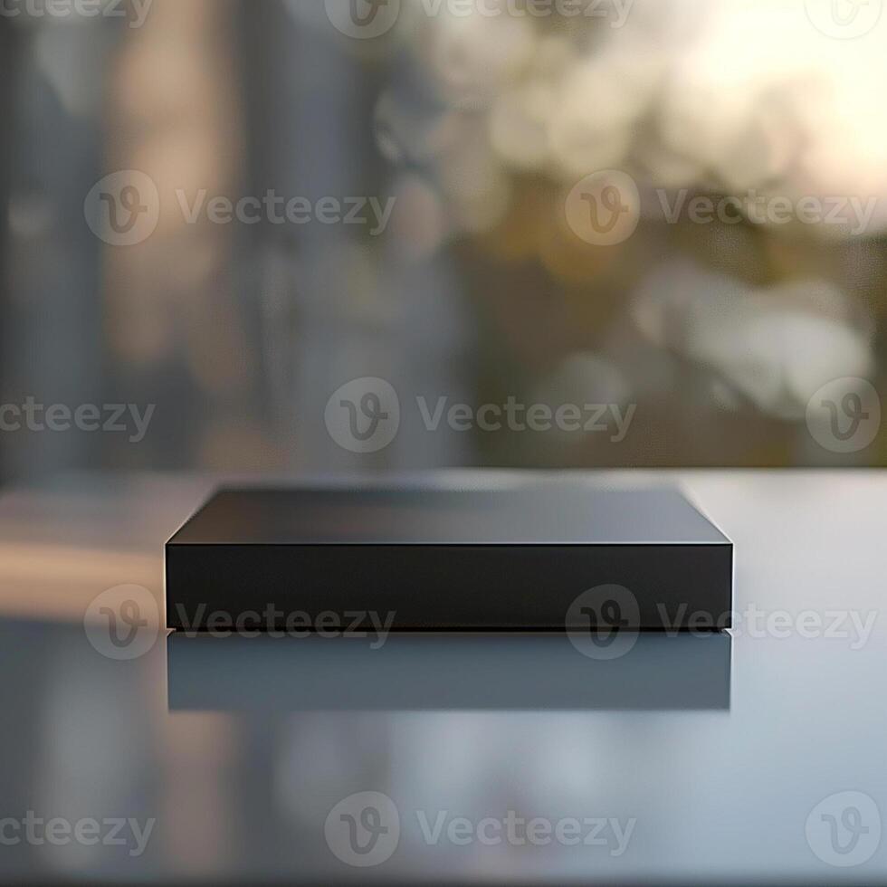 A black box sitting on a table in front of a window photo