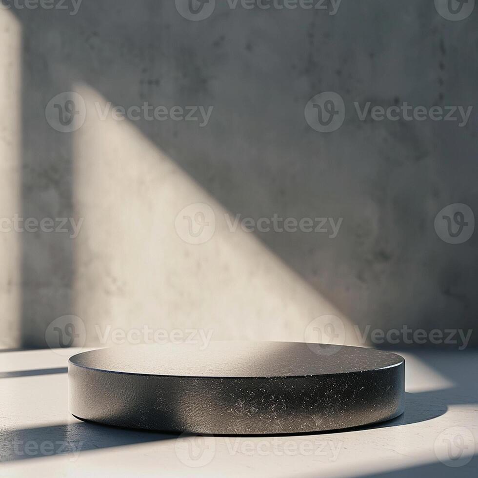 A black round table sitting in front of a wall photo