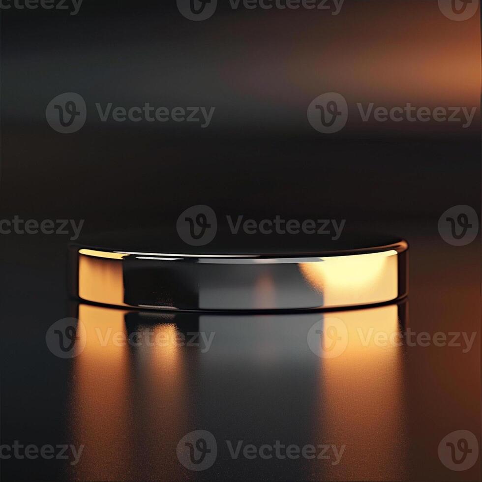 A round silver object on a black surface photo