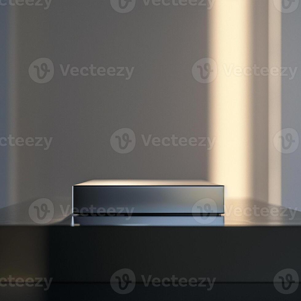 A silver box sitting on a table in front of a wall photo