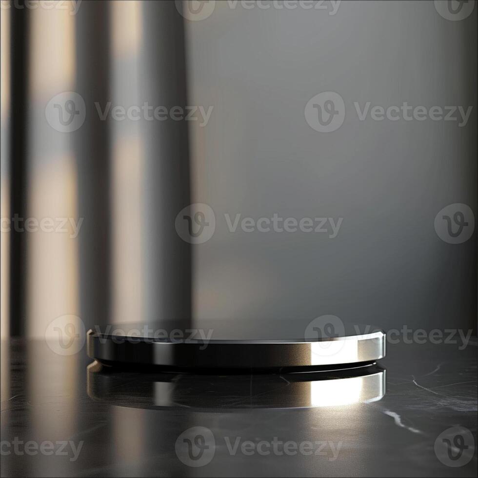 A black and silver circular object on a marble table photo