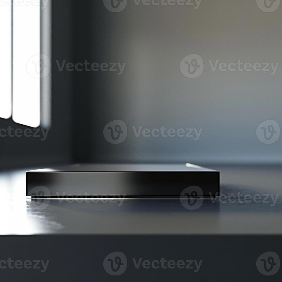 A black box sitting on a table in front of a window photo