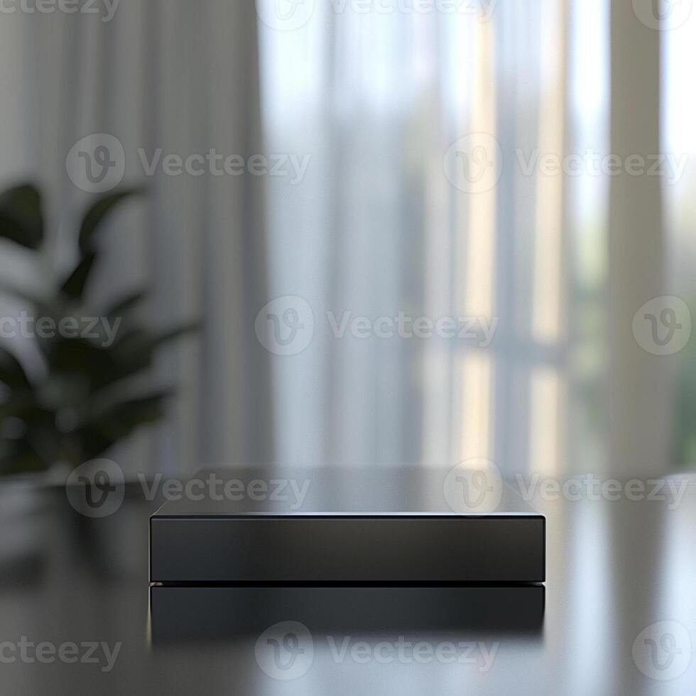 A black box sitting on a table in front of a window photo