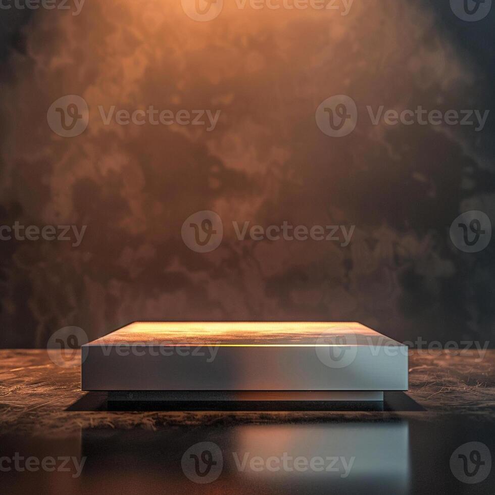 A silver box sitting on a table in front of a wall photo