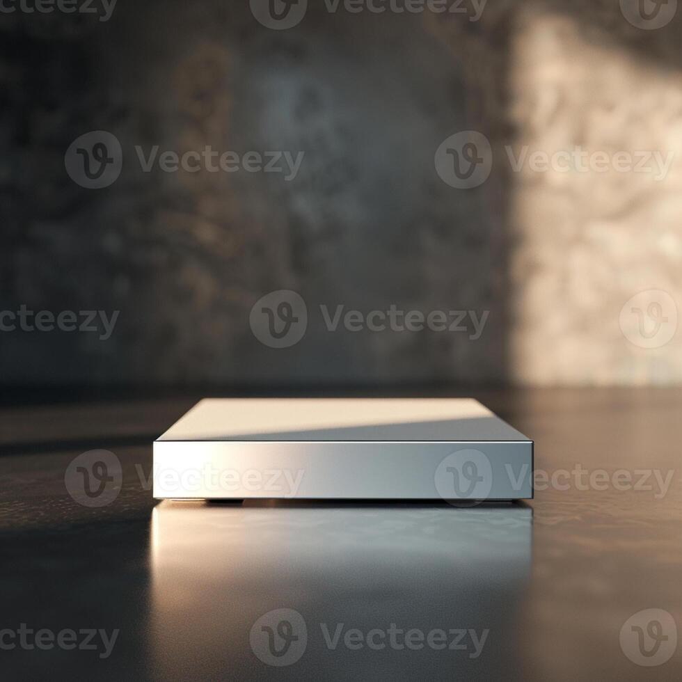 A white box sitting on a table in front of a wall photo