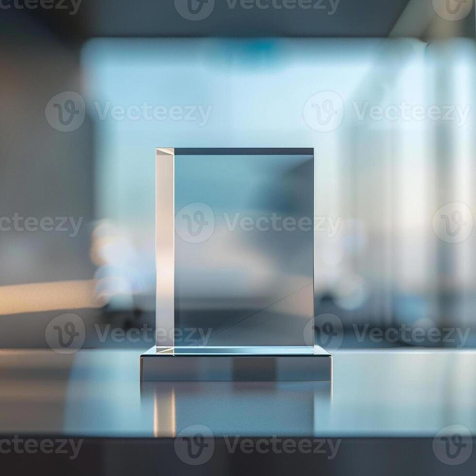 A glass award on a table in front of a window photo