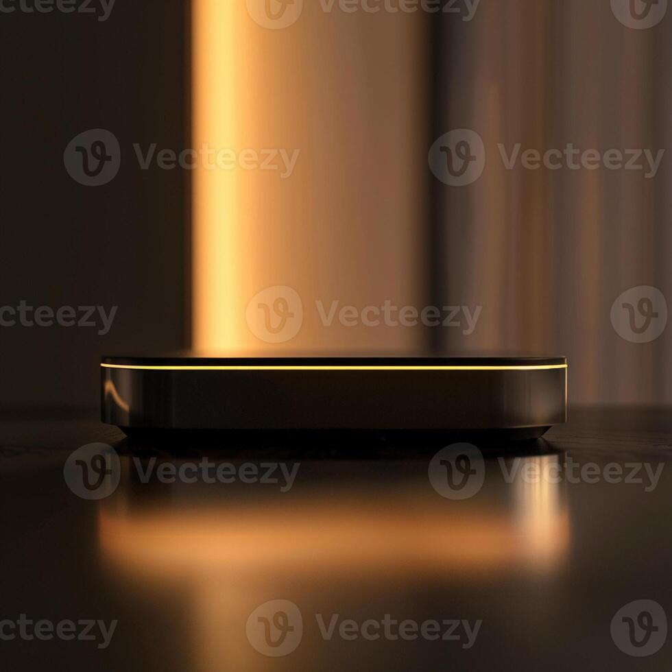 A black and gold device sitting on a table photo
