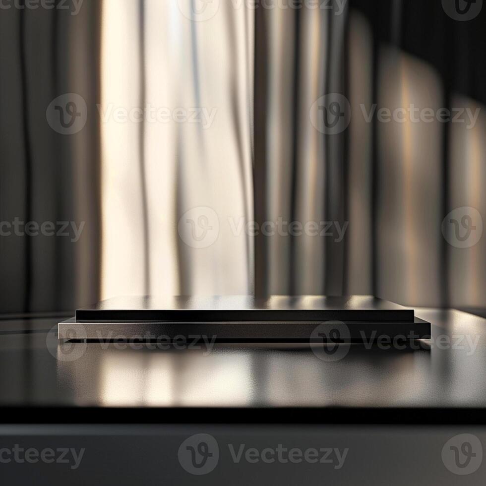 A black laptop on a table in front of a window photo