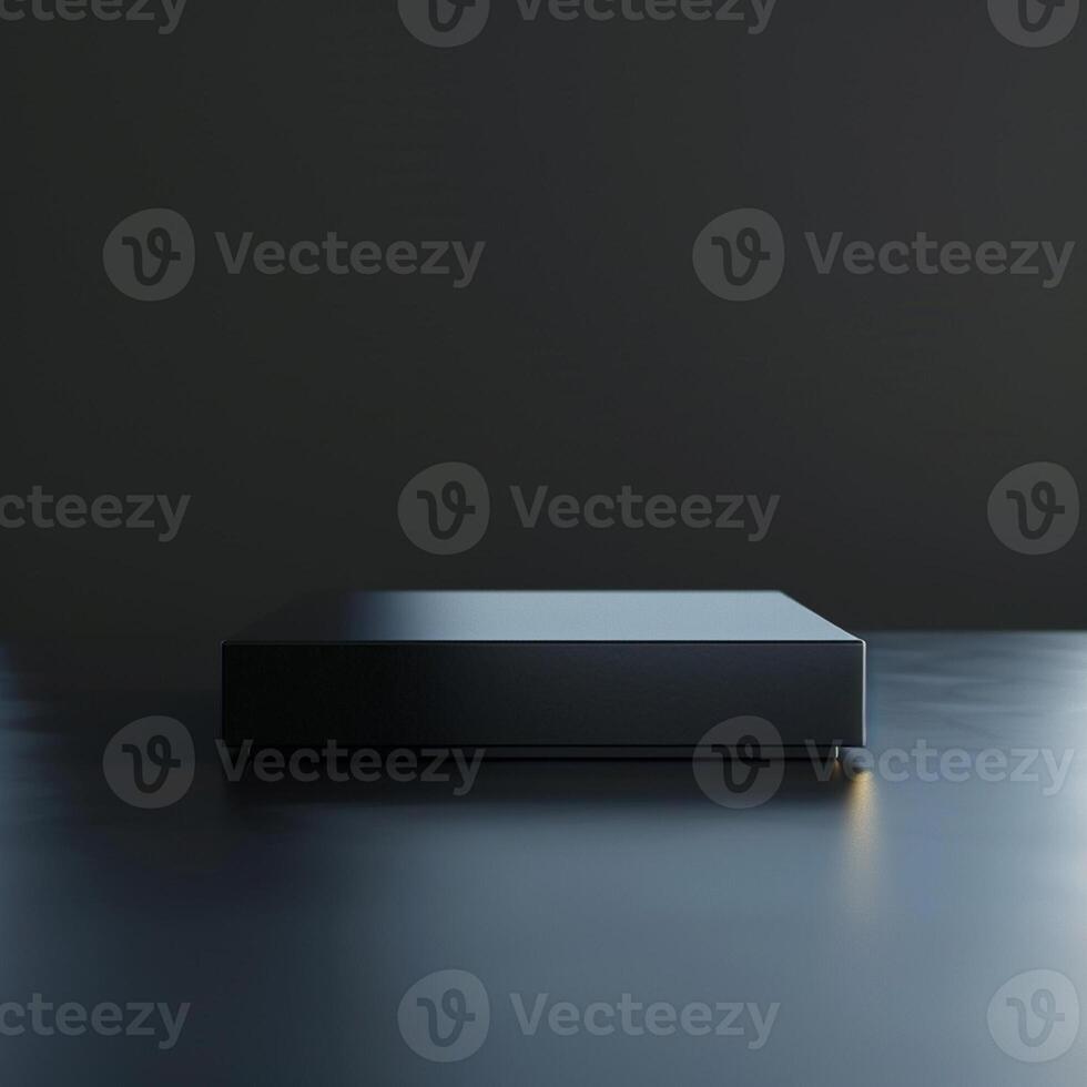 A black box sitting on a table in front of a dark wall photo