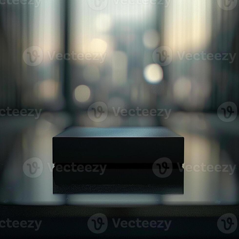 A black box sitting on a table in front of a window photo