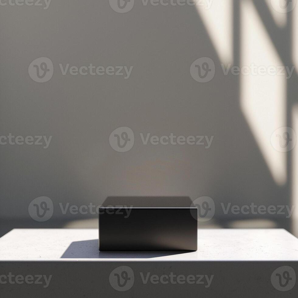 A black box sitting on a table in front of a wall photo