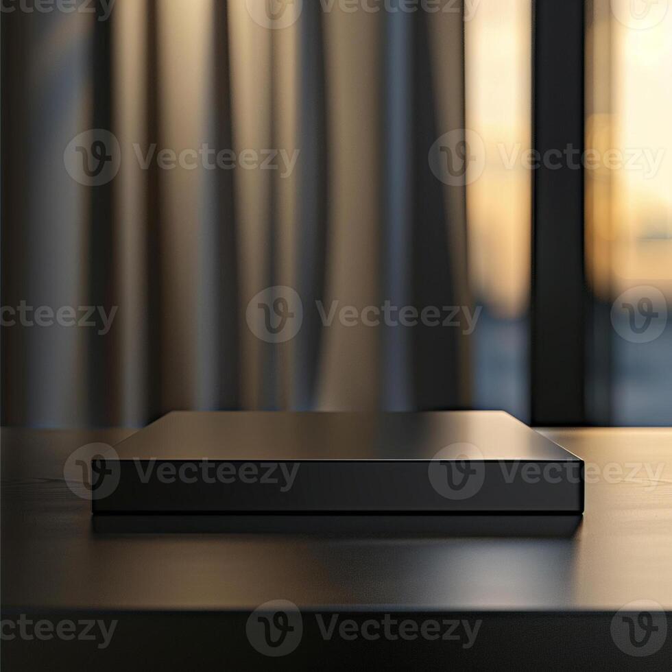 A black box sitting on a table in front of a window photo