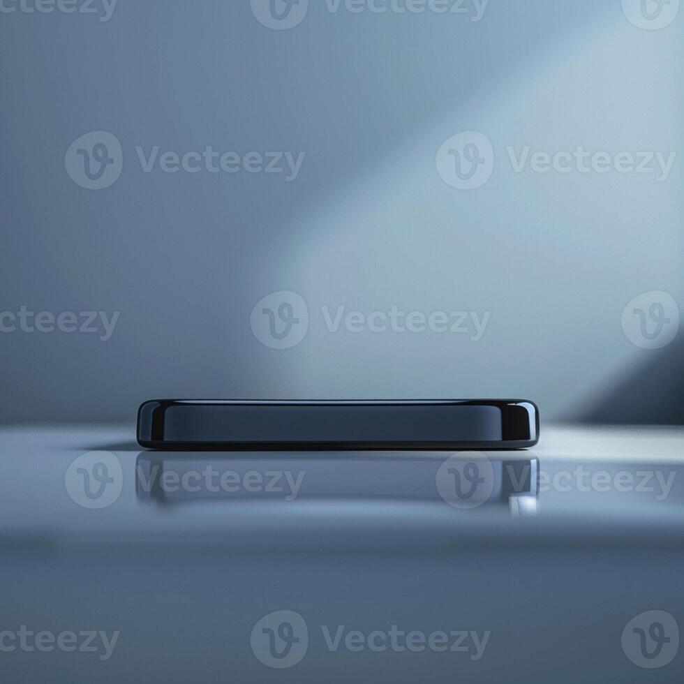 A black smartphone sitting on a table in front of a window photo
