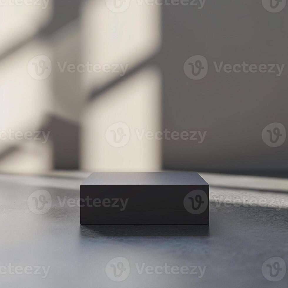 A black box sitting on a floor in front of a wall photo