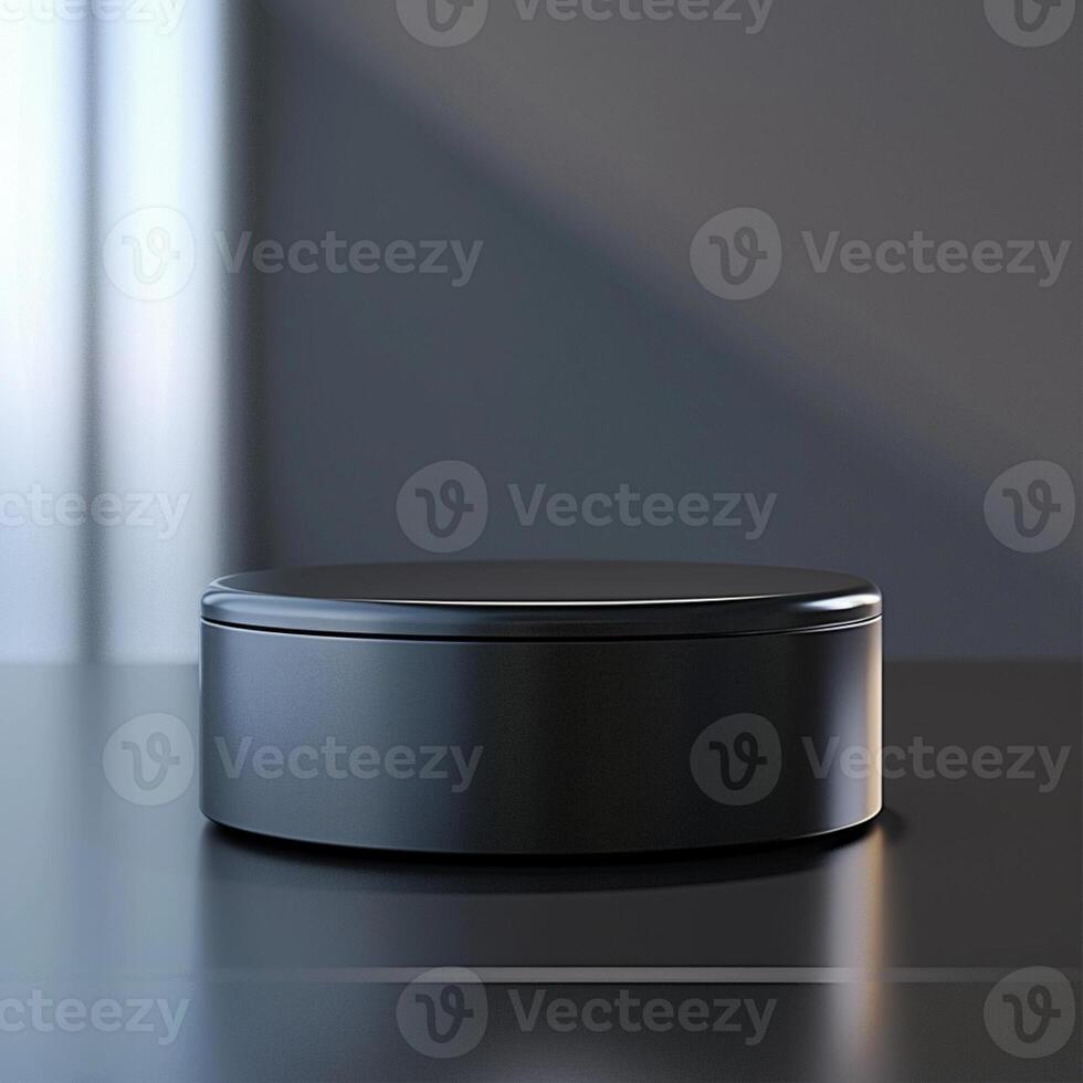 A black box sitting on a table with a light behind it photo