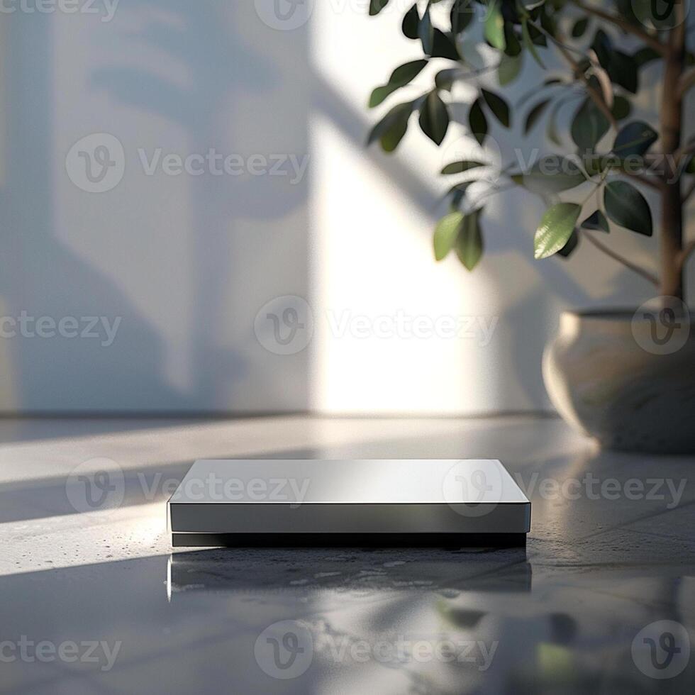 A white box sitting on a table in front of a plant photo