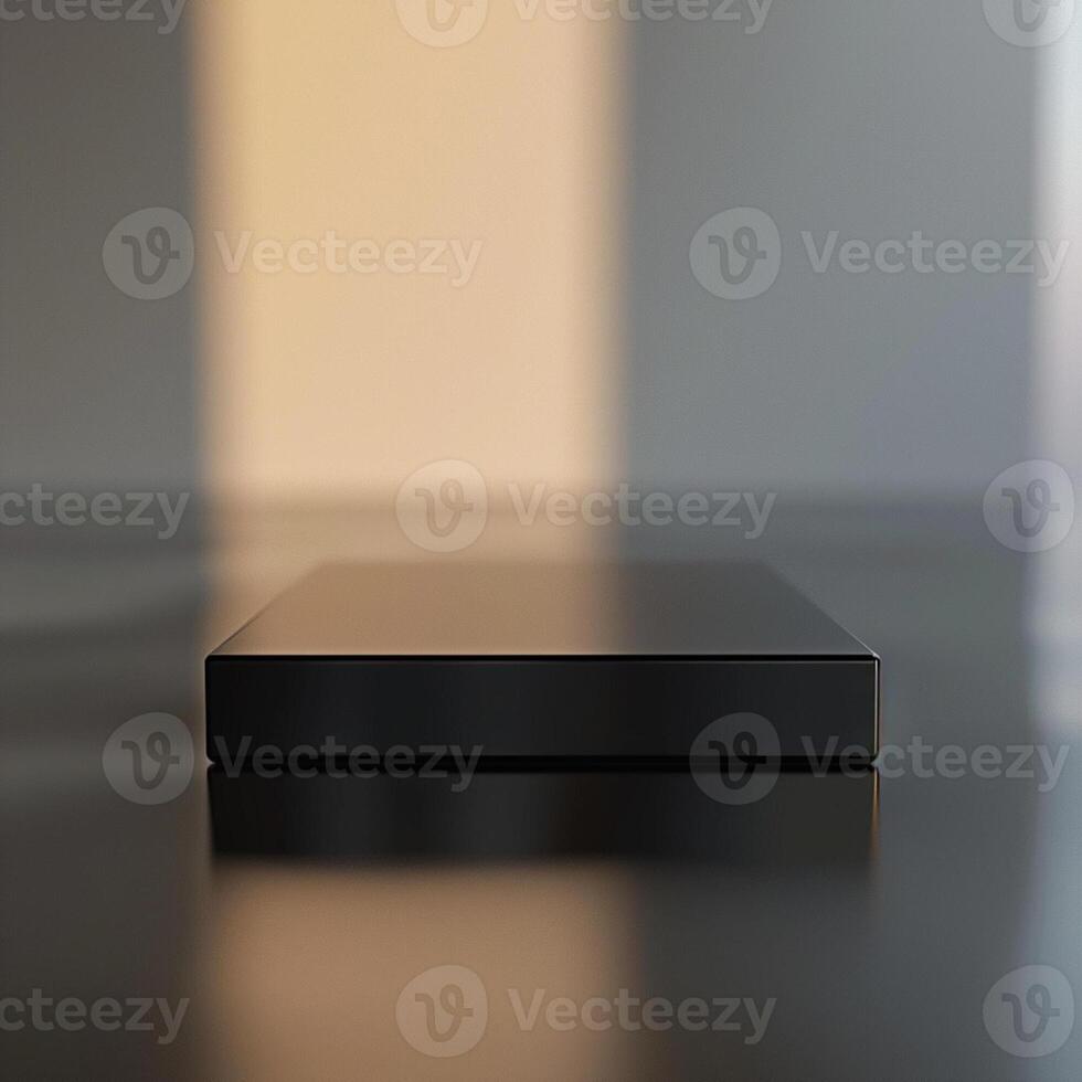 A black box sitting on a table with a light behind it photo