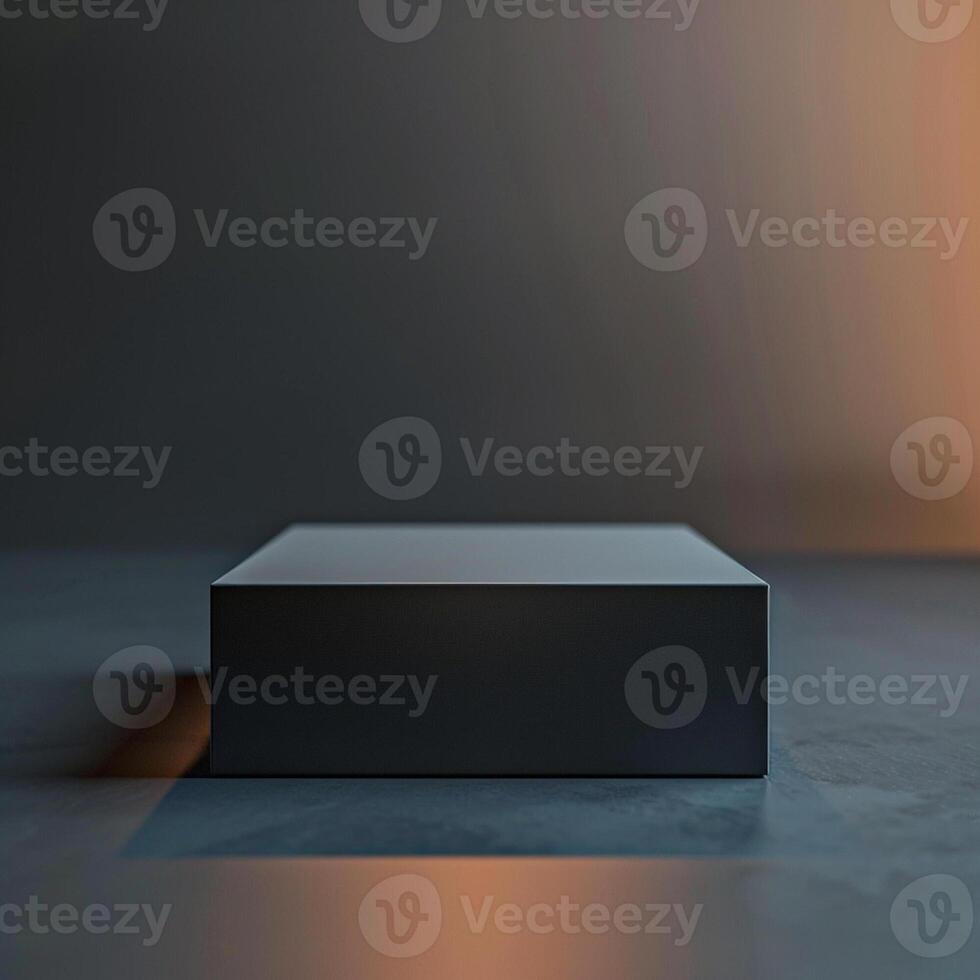 A black box sitting on a table in front of a wall photo