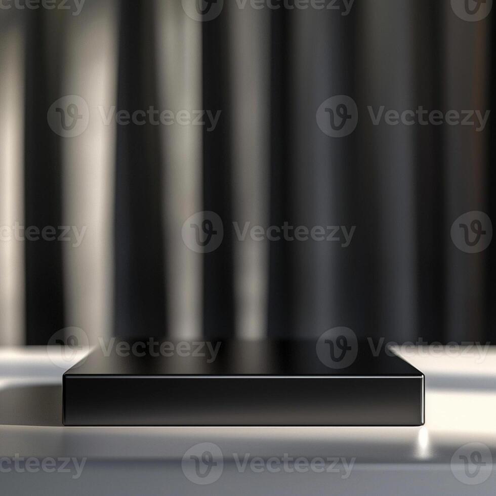 Black box on a table with a curtain in the background photo