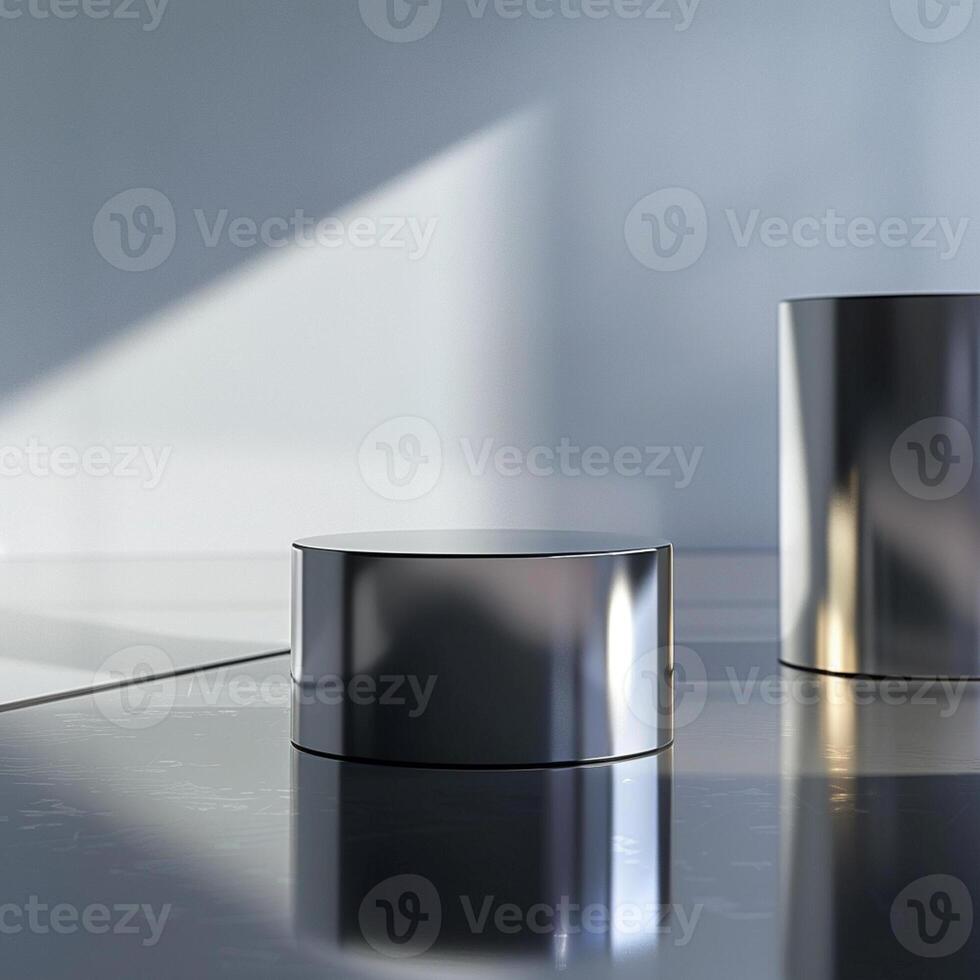 Two silver cylinders sitting on a shiny surface photo