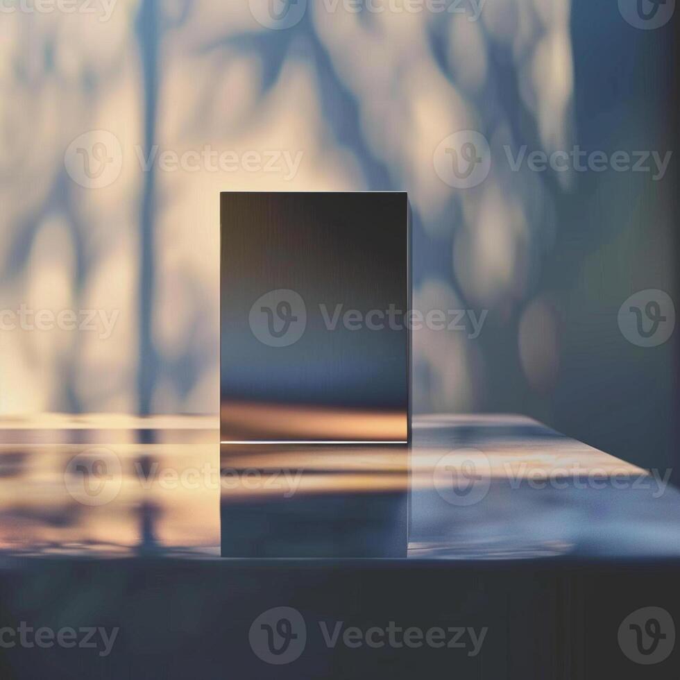 A square box sitting on a table in front of a window photo